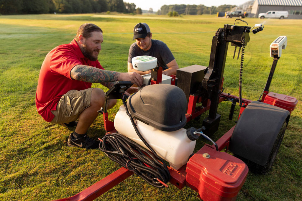 Turfgrass management professor Gerald Henry and graduate student A.J. Brown work with the Precision Sense 6000 in a turfgrass plot at the Athens Turfgrass Research and Education Center.