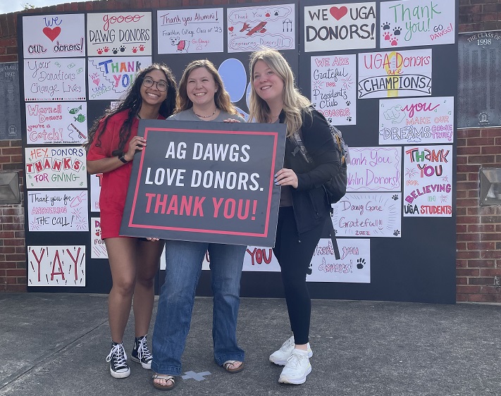 Students with "thank you donors" sign